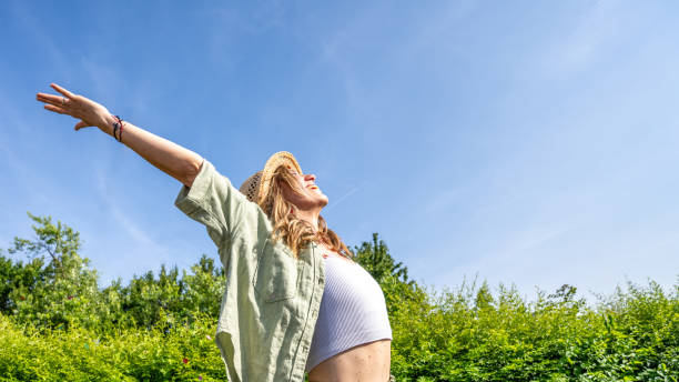 istock Women standing with arm outstretched 1673542976