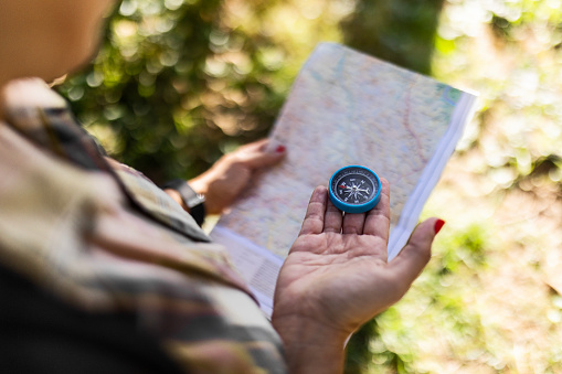 Hiking Woman Traveler With Backpack Checks Map to Find Directions