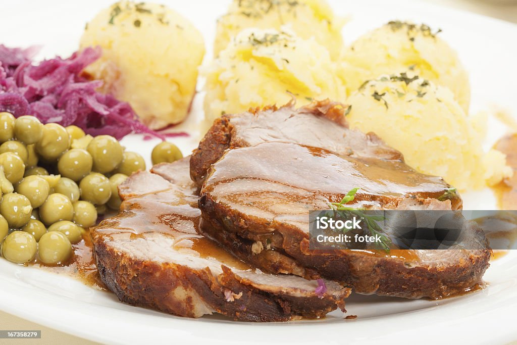 Roast pork with sauce and potatoes Roast pork with sauce. Selective focus. Pork Stock Photo