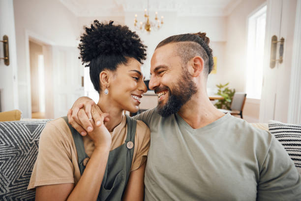istock Happy, love or interracial couple on a sofa, care or commitment with relationship, weekend break or loving together. Home, man or woman on a couch, marriage or romantic with bonding, date or relax 1673585834