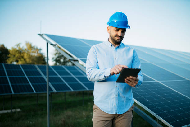 istock Young man working with digital tablet at renewable energy farm 1673587938