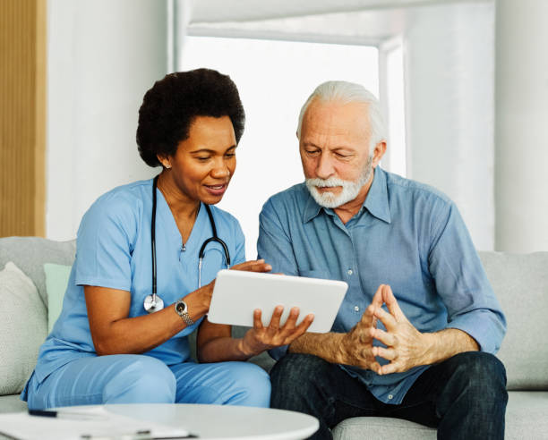 istock nurse doctor senior care tablet computer technology showing caregiver help assistence retirement home nursing elderly happy laughing man 1673588487