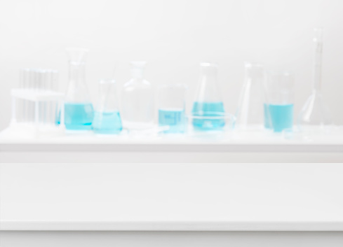 Blank table on abstract blurred background of chemical lab equipment