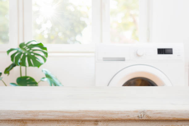 istock Table space for product montage on blurred washing machine background 1673589634