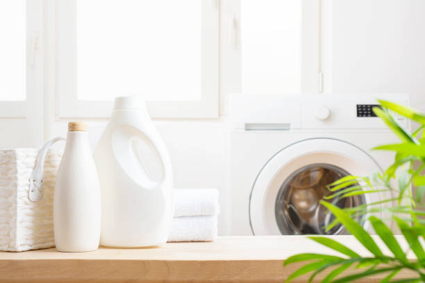 istock Detergents on table with basket and towels in laundry room 1673589636
