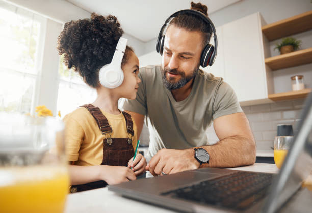 istock Father, child and headphones on laptop for home education, e learning support and helping with translation. Happy dad, family and boy kid on computer and listening to audio for language and teaching 1673590698