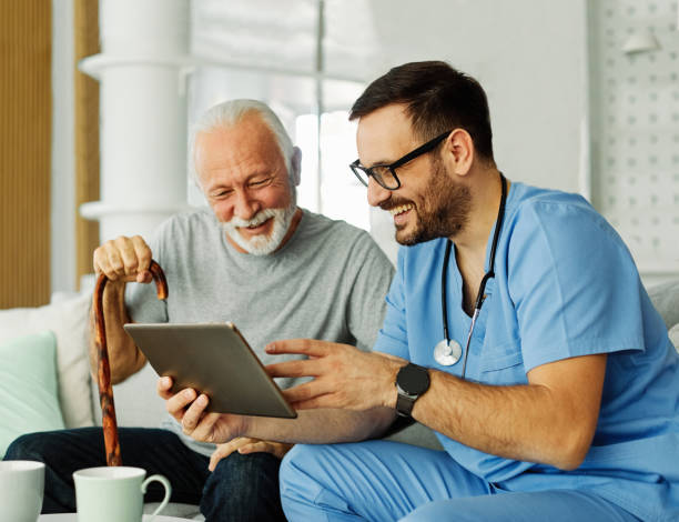 istock nurse doctor senior care tablet computer technology showing caregiver help assistence retirement home nursing elderly happy laughing man 1673590706