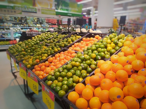 Fruit stall, various types of citrus fruits for sale in the supermarket.