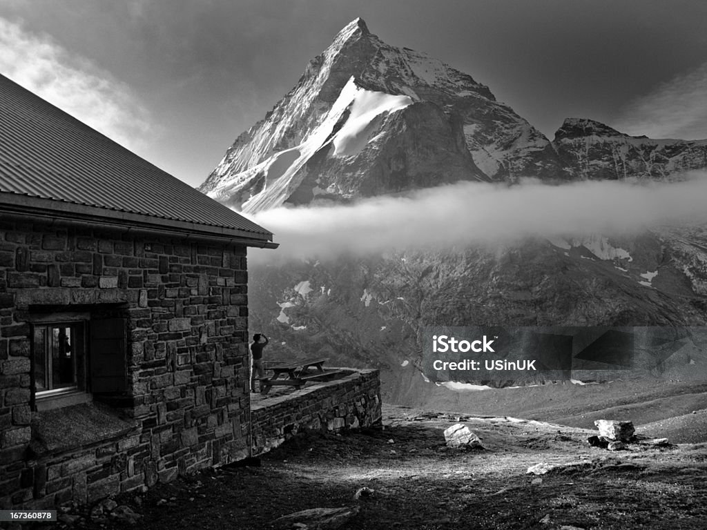 The Matterhorn from Schonbielhutte Taken from Schonbielhutte (2694m) four hours hike from Zermatt, Switzerland. The person taking the picture in the foreground is a Sherpa from Nepal who stayed overnight at the hut whose unplanned presence really makes this shot. European Alps Stock Photo