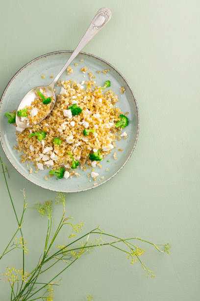 istock Bolgur with feta cheese and broccoli 1673610049