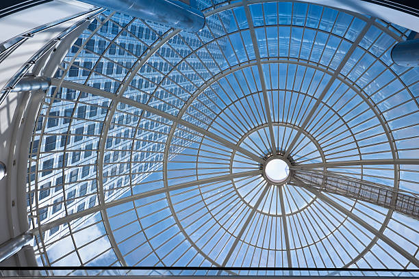 Office Building Seen Through Glass Roof futuristic architecture in sunset light, toned image, architecture capital cities glass pattern stock pictures, royalty-free photos & images