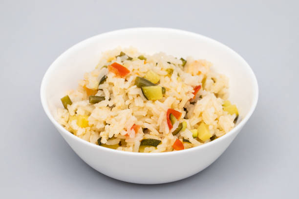 istock Cooked white rice mixed with colorful vegetables onion, green beans, tomato 1673612784