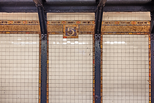 The name of the station - 5th Avenue - written with tiles on the wall of the old station