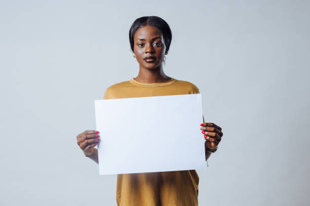 istock Young Adult Holding Blank Sign 1673641876