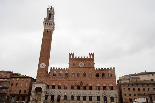 Padua, PD, Italy - May 15, 2022: Ancient Palace called DELLA RAGIONE on the Fruits and Vegetables Square called Piazza della Frutta in italian language and old tower