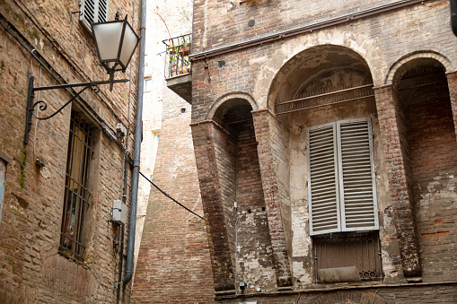 Facade with balcony of historical buildings in the city of Padua in Italy. Typical wall view with architectural details. Brickwork.Travel destination in Italy concept