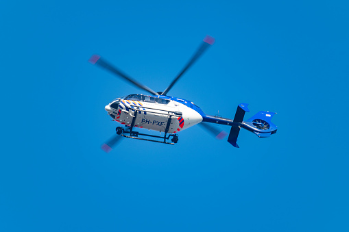 Helicopter Eurocopter - EC135 of the Dutch Police Aviation Service fitted with camera's for surveillance. The Helicopter is flying in mid air