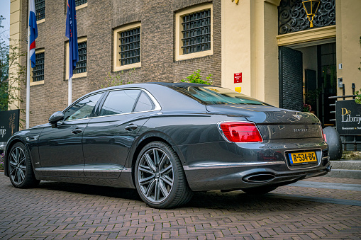 Bentley Flying Spur luxury sedan parked on the street in front of three star Michelin restaurant Librije in Zwolle, Overijssel, Netherlands.