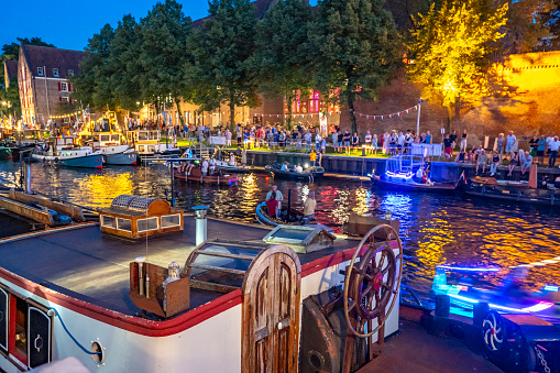 Vintage tugboats and pusher boats in the Thorbeckegracht canal in Zwolle during the national Heritage Days with a parade of small pusher boats (opduwers) in the evening.