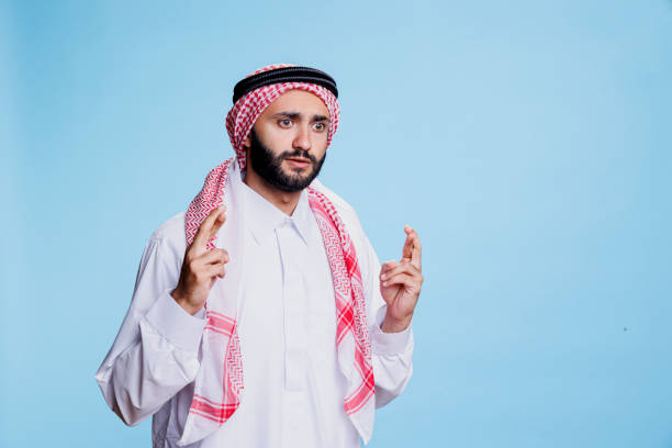 istock Scared muslim man with crossed fingers 1673702379