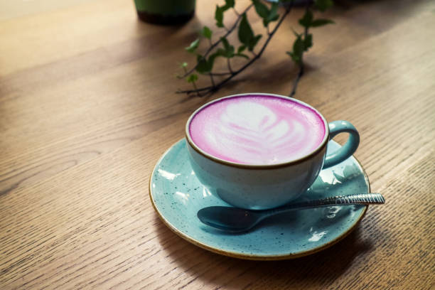 istock Cup of pink cappuccino in blue cup 1673713287