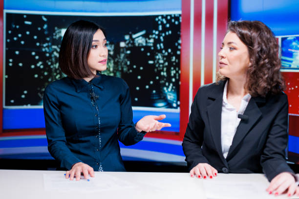 istock Women presenters talk about latest news 1673716669