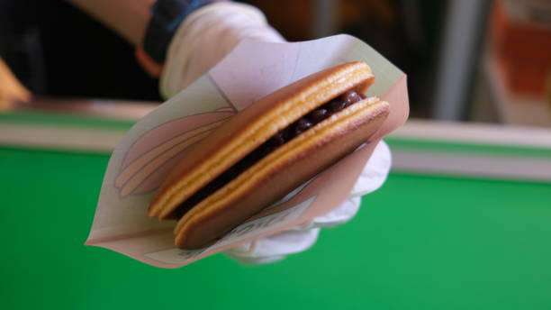 istock hand holding Dorayaki cake. 1673739703