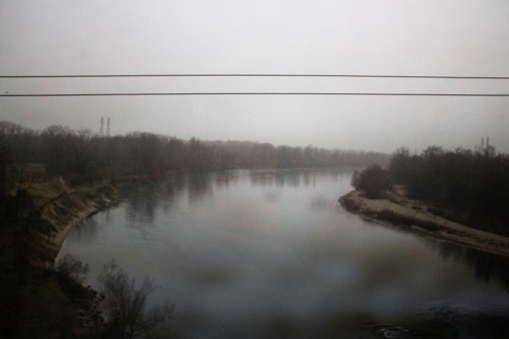 evocative image of the Po river seen from a road in winter with fog in Italy