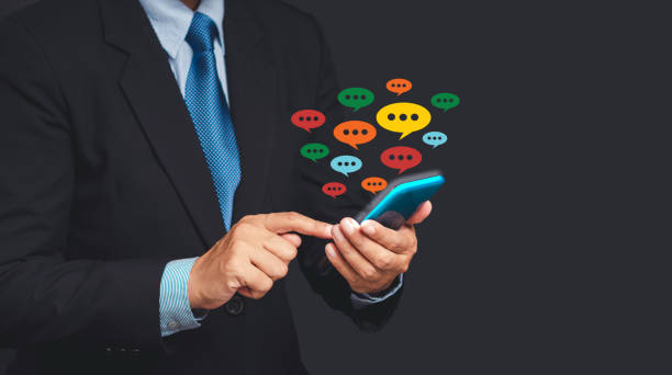 istock Close-up of hands using mobile phone with colorful chat icons on application communication digital web and social media 1673777147