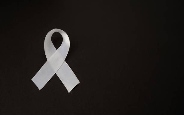 istock Top view of a white ribbon on a black background 1673782695