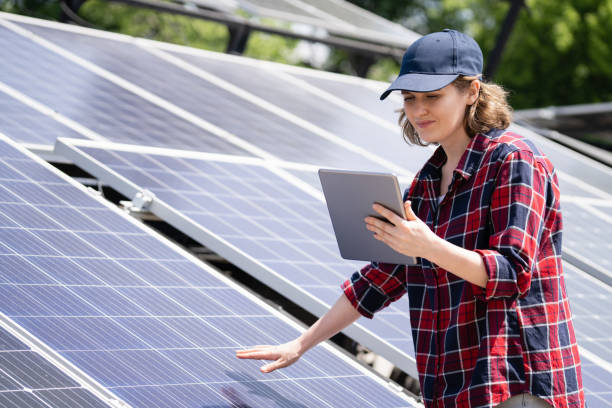 istock A woman engineer is standing next to solar panels and holding digital tablet in her hands. 1673788163