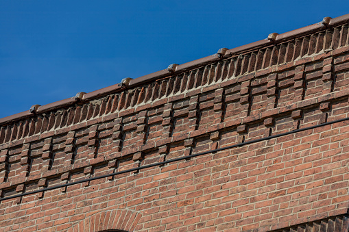 old brick buildings facade details at the top of the building