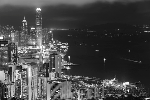 Night scenery of dwontown district and Victoria Harbor of Hong Kong city