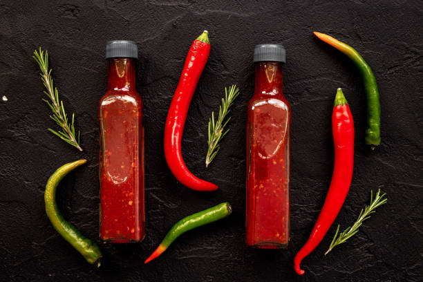 istock Tabasco hot pepper sauce with red chili pepper, flat lay 1673802586