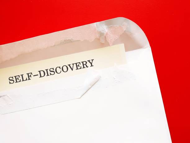 istock Torn envelope on red background with text SELF-DISCOVERY, to consider what you want from life, to uncover path to achieve main goals 1673805343