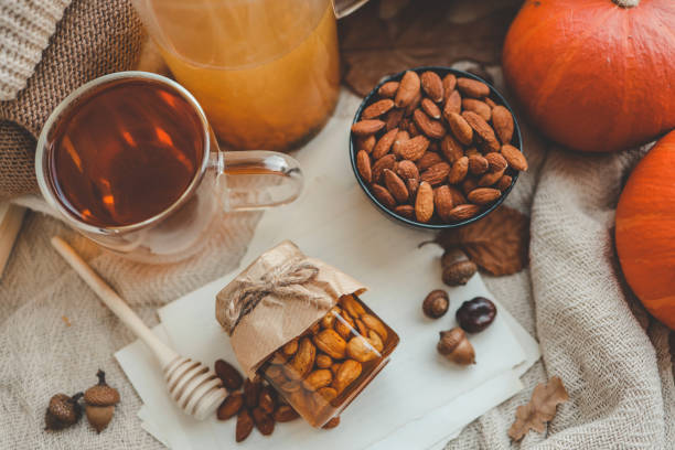 Jar with craft sweet honey and nuts in autumn interior