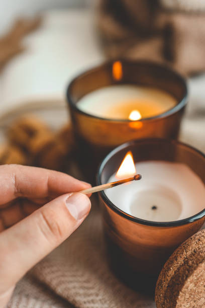 istock Match in hand lights a candle, cosiness concept 1673820228