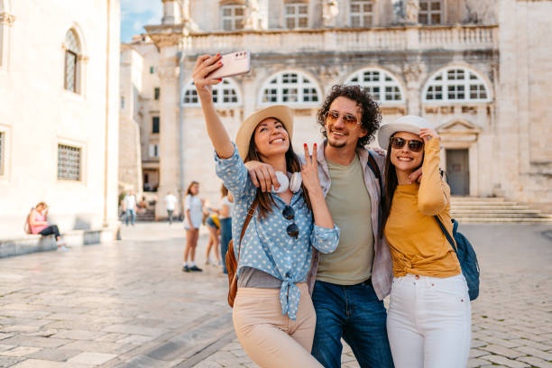 istock Three Young Friends Taking Selfies On The Town Square In Dubrovnik 1673825873