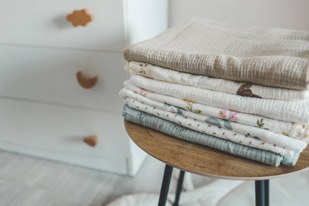 istock Stack of baby muslin blankets and newborn diapers 1673832040
