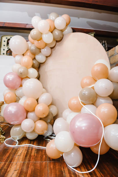 istock Wedding reception. Arch on background balloons, party decor. Photo-wall decoration space or place with pink, brown, and gold balloons. Trendy autumn decor. Celebration baptism concept. Birthday party. 1673832595