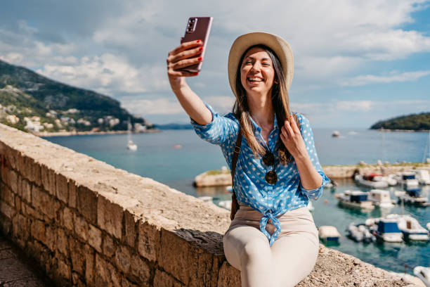 istock Young Woman Taking Selfies In Dubrovnik Bay 1673835334