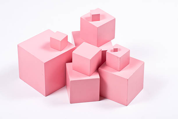 Montessori Pink Cubes Montessori Pink Tower building blocks - sensorial material for elementary education. Isolated on white. montessori stock pictures, royalty-free photos & images