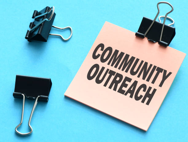istock COMMUNITY OUTREACH sign written on sticky note 1673848511