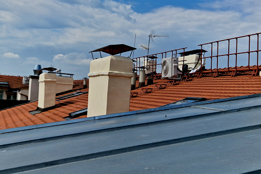 chimneys with several pipes in apartment buildings were swept by several chimney sweeps who walked along wire grid walkways similar to ramps or suspended rungs between the roofs.