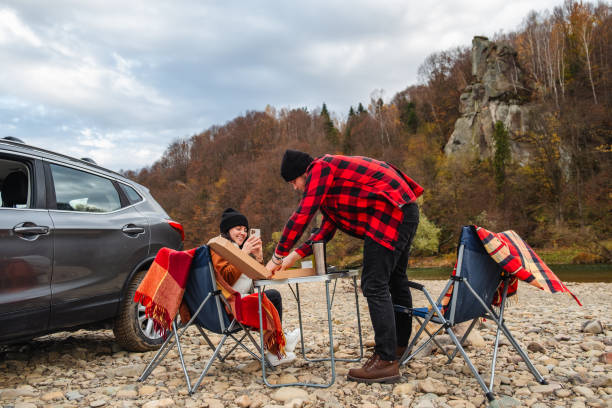 istock couple having picnic at autumn mountain river 1673860004