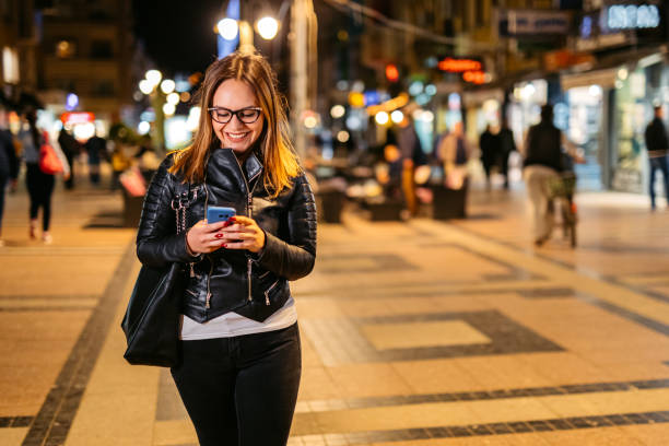 istock Young Woman Using Her Phone On The Street 1673877550