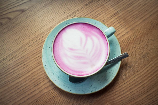 istock Cup of pink cappuccino in blue cup 1673882474