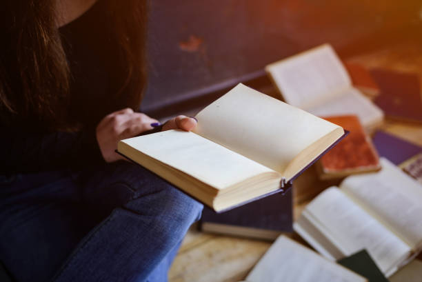 istock Close up of hands holding an old book. 1673890206