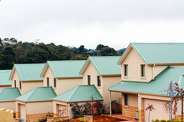 istock Townhouses with green corrugated iron roofs, copy space 167389920