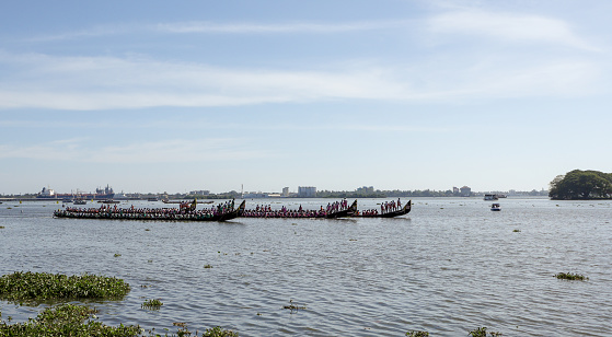 Kochi, Kerala, India-October 8 2022; A Few Long Snake boats lined up large groups of Oarsmen during the 'Vallam Kali' Onam festival in Kochi ocean, India.